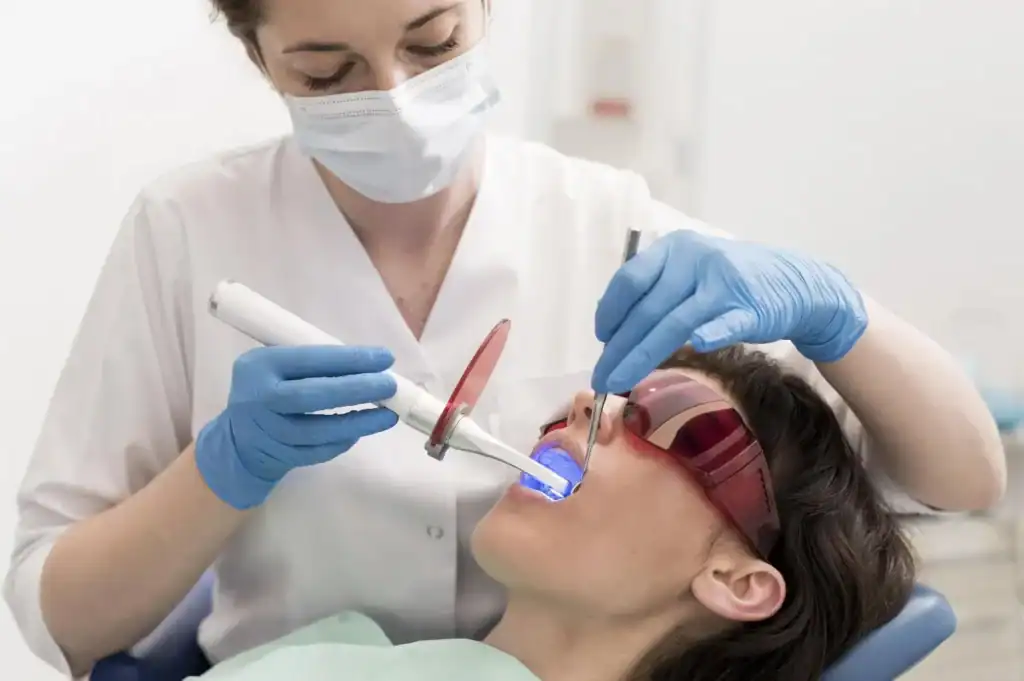Female patient undergoing advanced zoom Laser Teeth Whitening session with dental specialist Hampshire