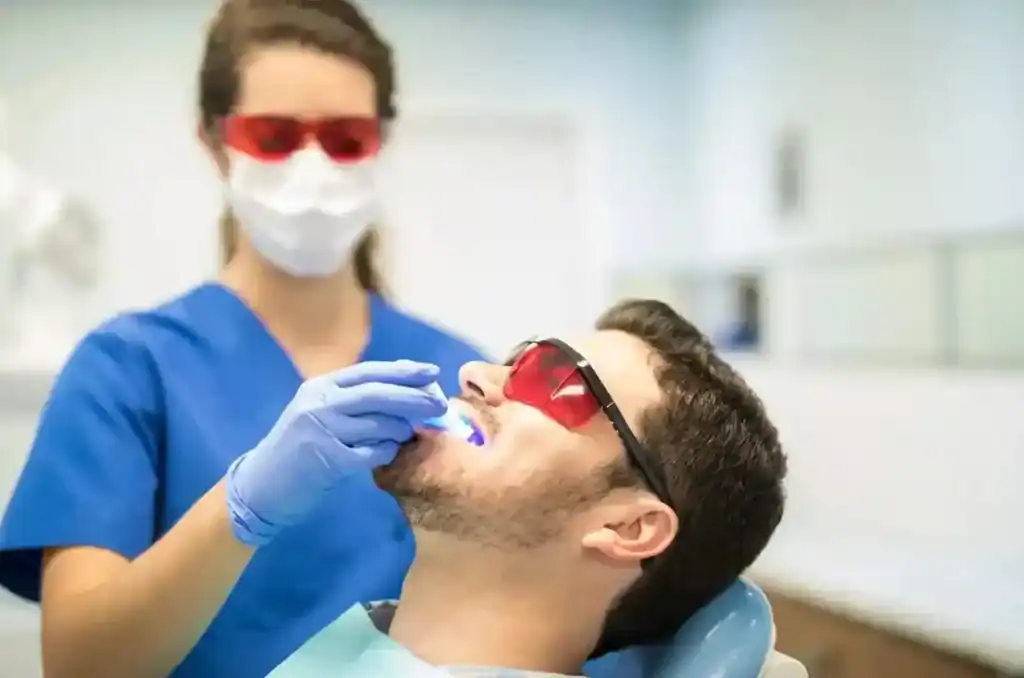 Close-up of Zoom Laser Teeth Whitening procedure being administered to a male patient Hampshire